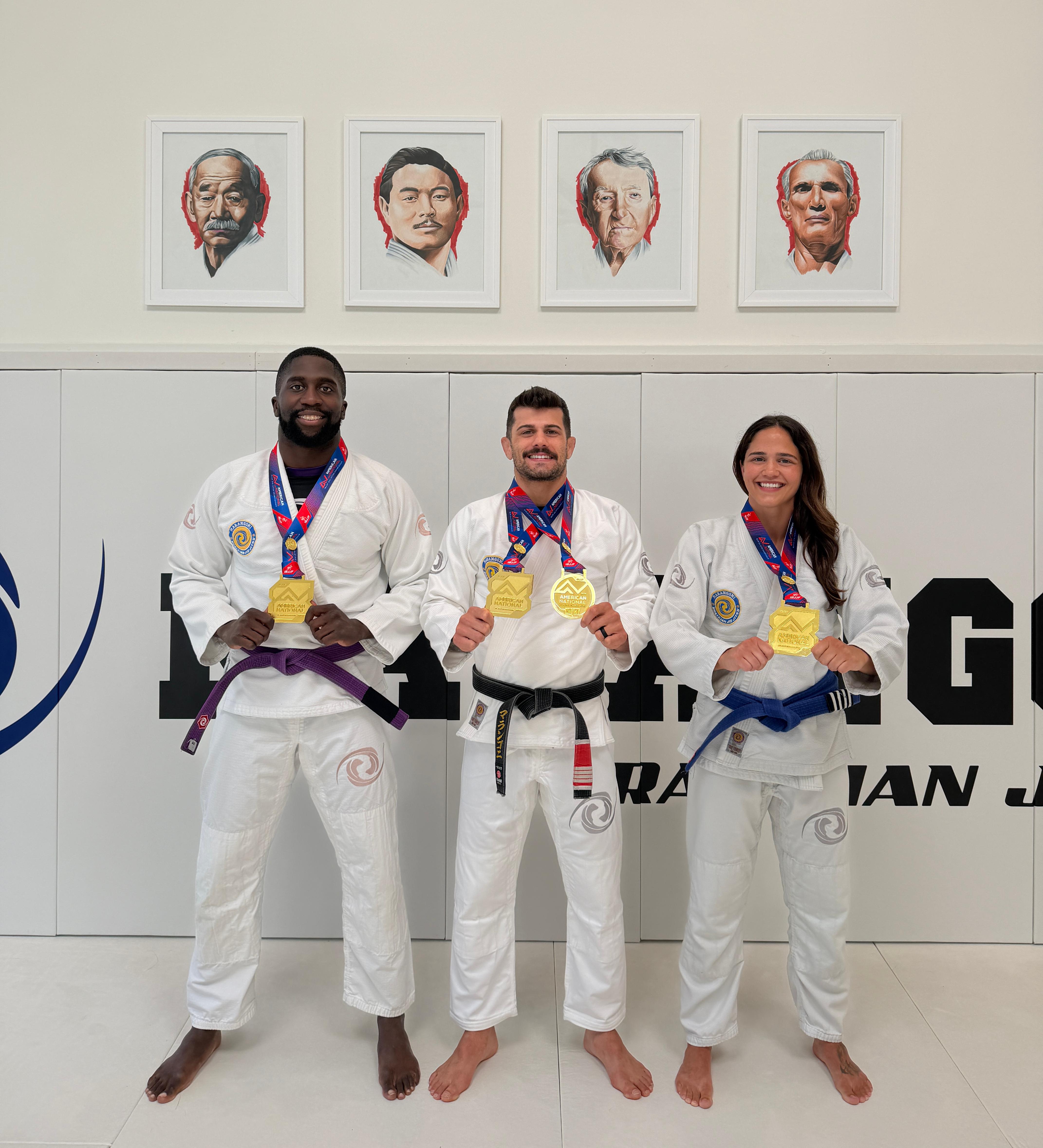 Christian Kouassi, Professor Gabriel Marangoni, and Kathleen Tripp with their gold medals at Marangoni BJJ Salt Lake City